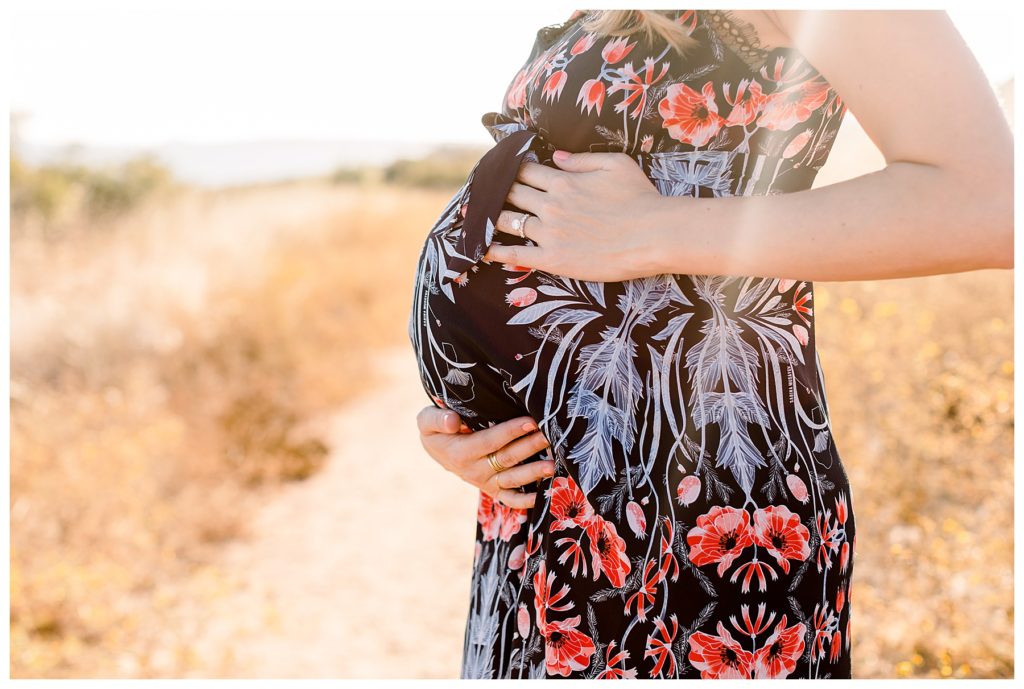 A Gorgeous Sunset Maternity Session in Malibu close up of pregnant belly
