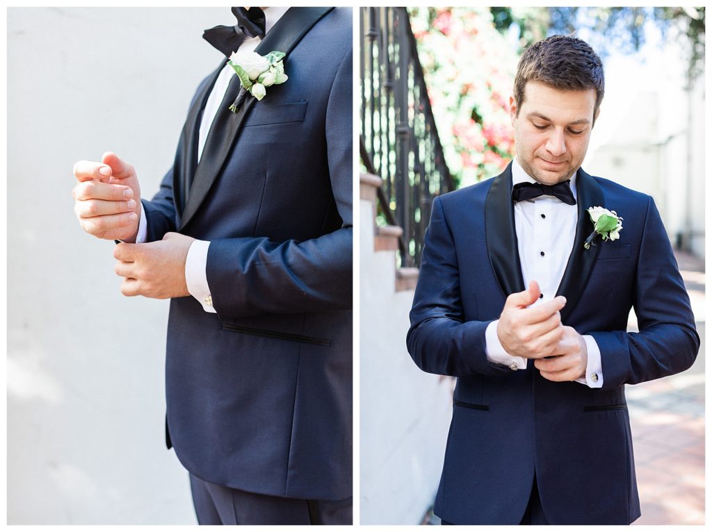 A groom in a navy tux getting ready