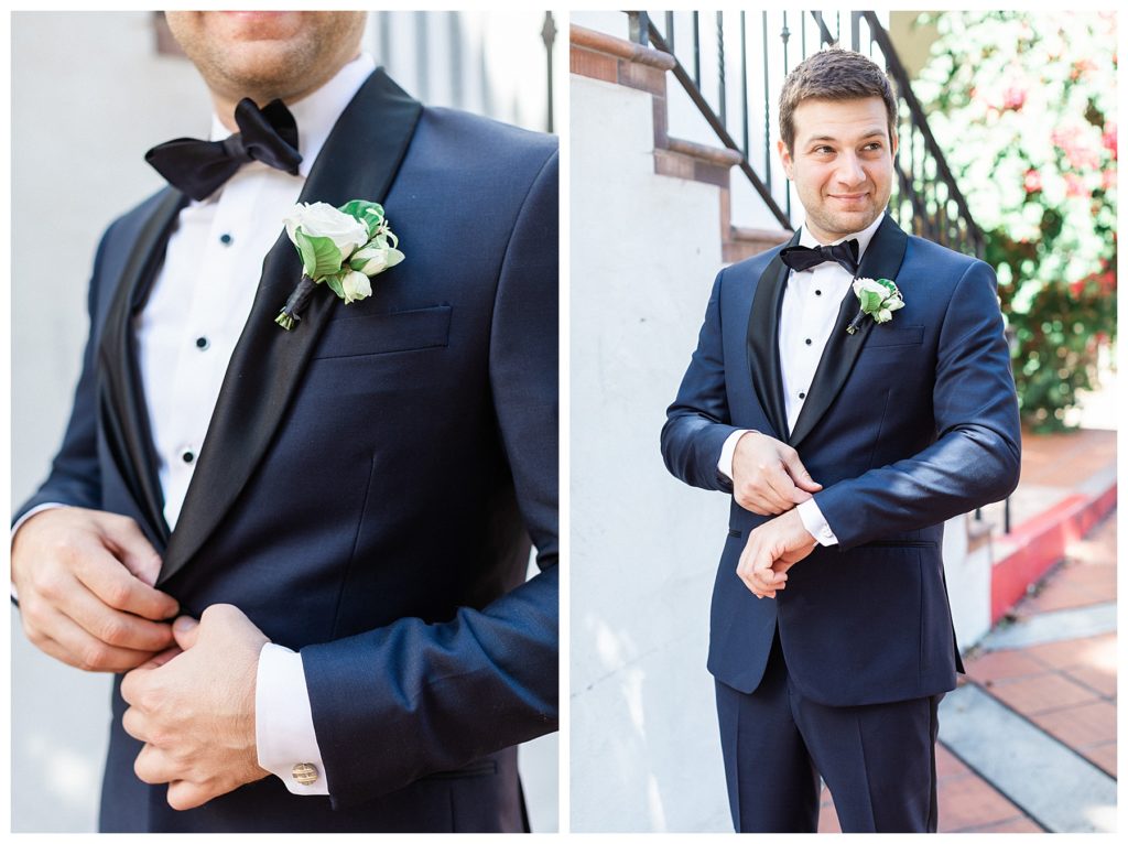 A groom in a navy tux getting ready