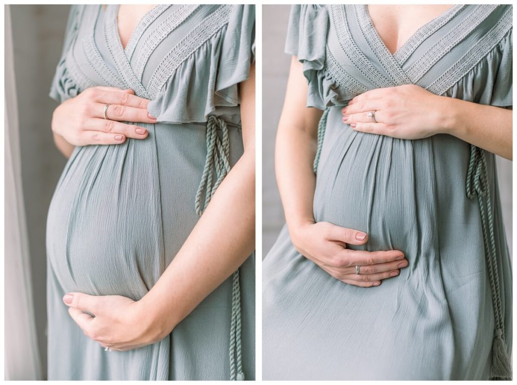 Images show a close-up of a woman's pregnant belly, she is wearing a sage green dress with light pink nail polish for her maternity photos.