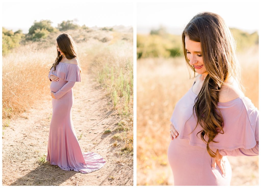 Image shows a pregnant woman at her maternity session in a field wearing a long pink dress. 