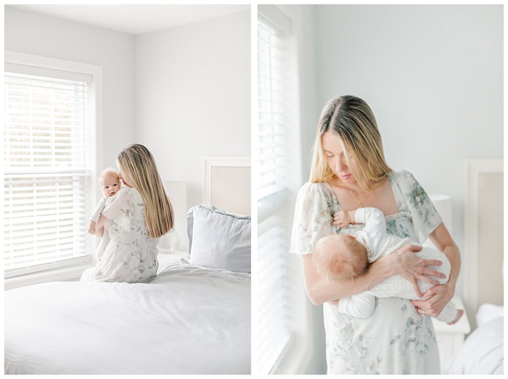 A new mother holding her baby while standing and sitting by a window during her in-home newborn photo session.