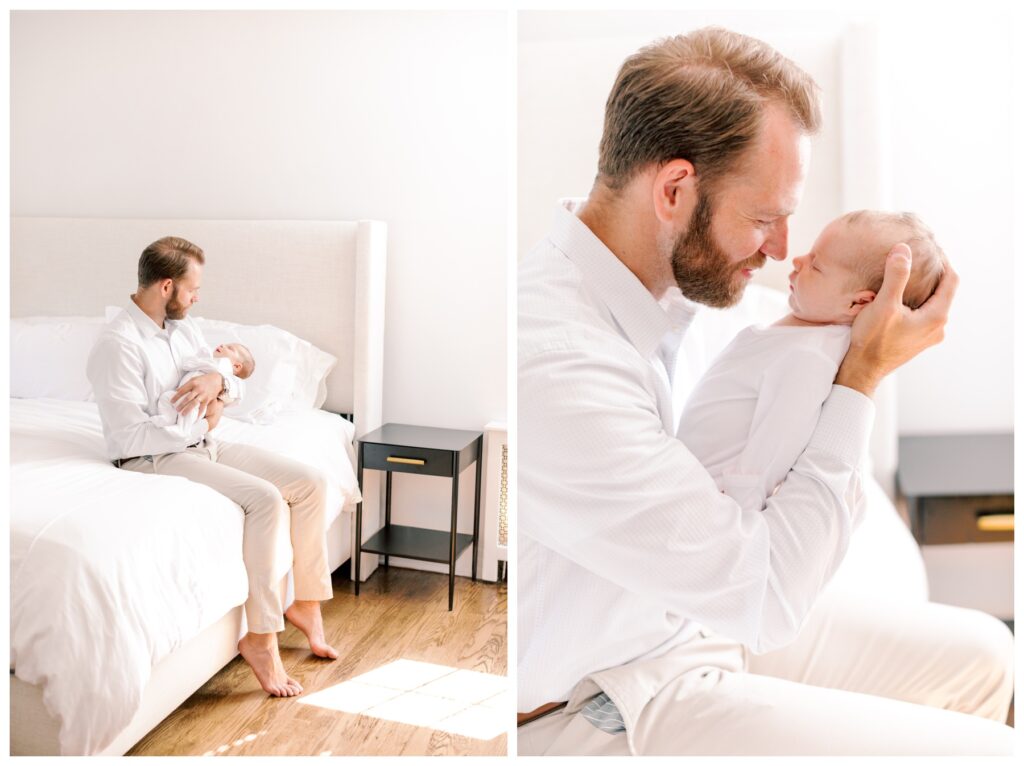 A father sits on the bed and holds his newborn daughter during an in-home newborn session