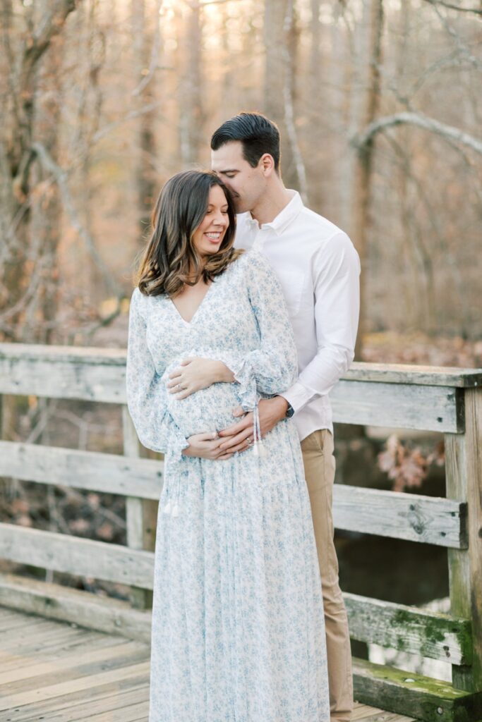 A couple poses during maternity photos at Loantanka Brook Reservation