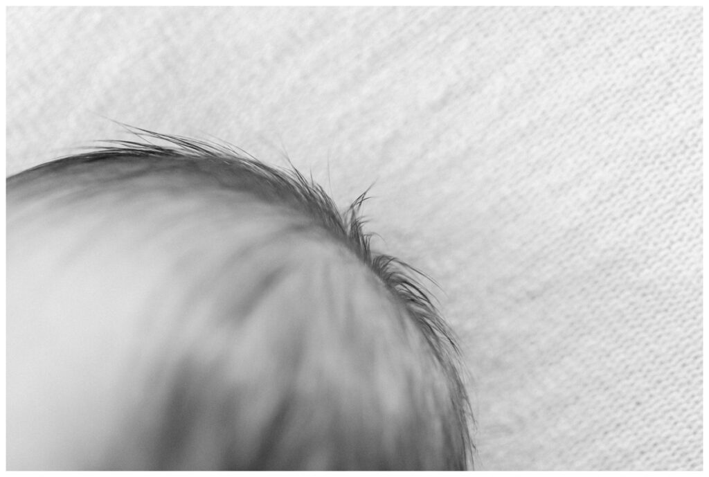 Close up detail image of a baby's hairduring newborn photos at home