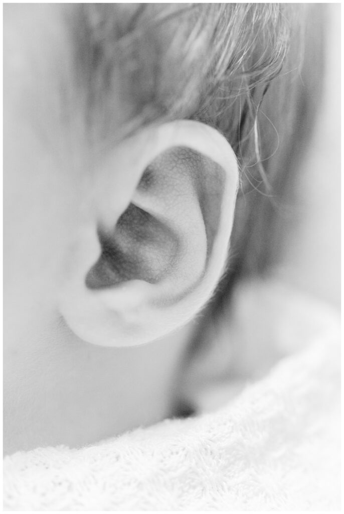 Close up detail image of a baby's ear during newborn photos at home