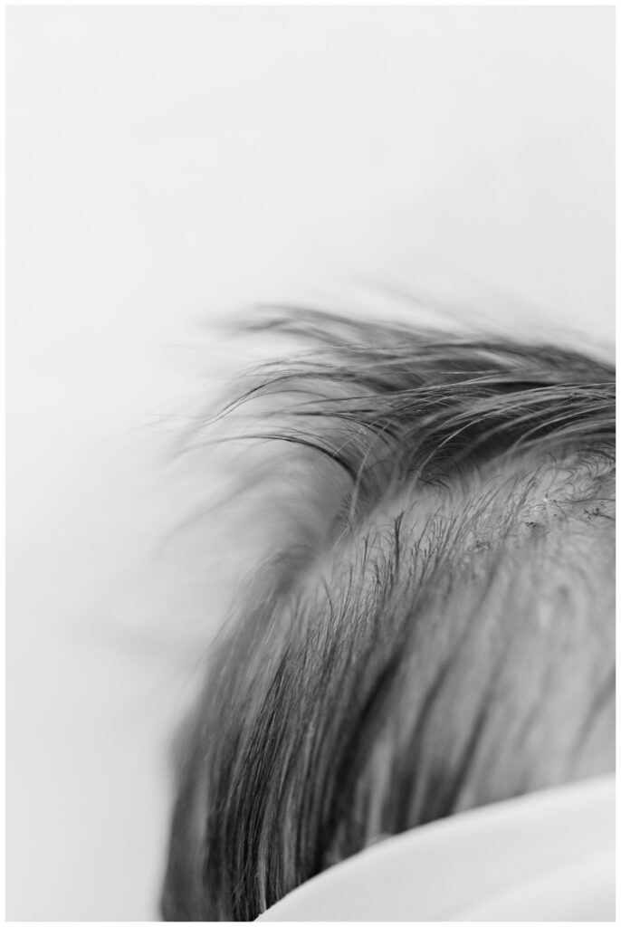 Close up detail image of a baby's hair during newborn photos at home