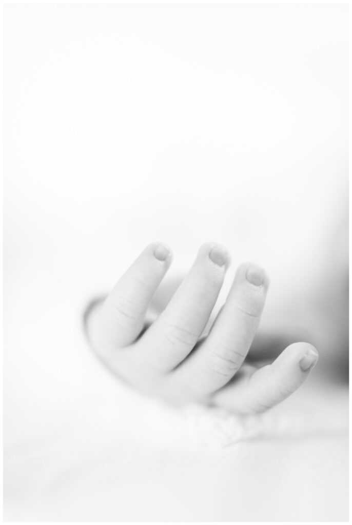Close up detail image of a baby's fingers during newborn photos at home