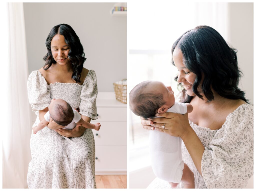 A mother sits in her newborns nursery and holds him in front of her during her lifestyle in-home newborn session. She is wearing a white dress with small gray flowers on it.