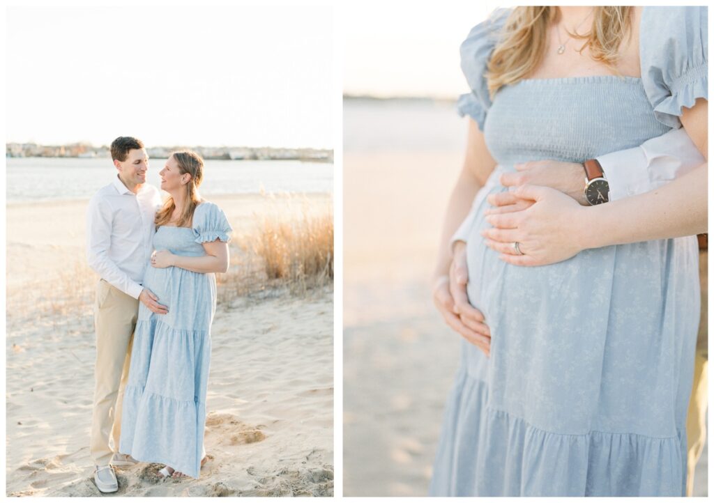 A couple poses together during their beach maternity photos. she is wearing a long blue dress with short sleeves