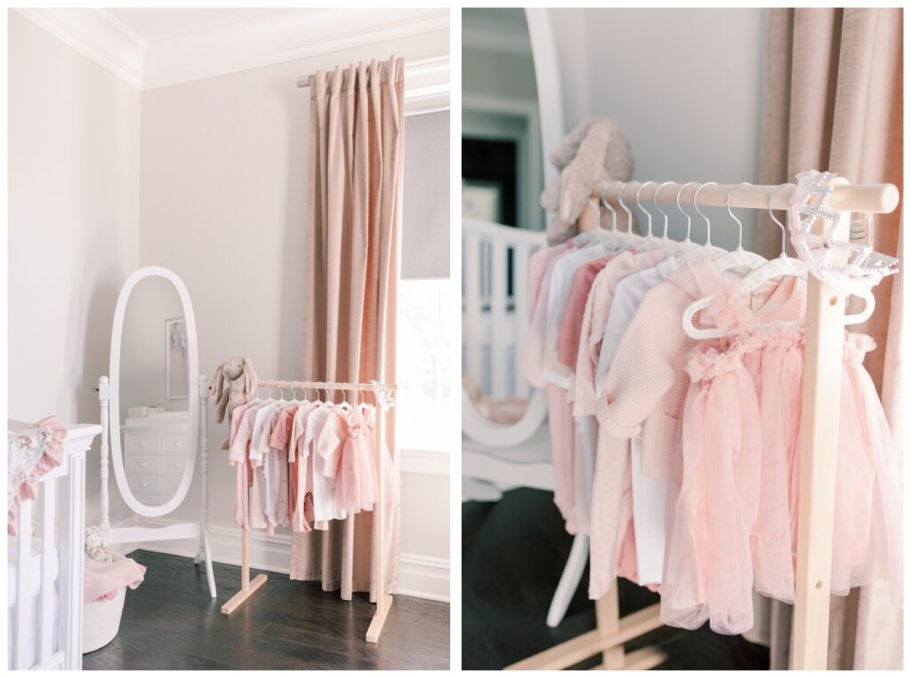 Details in a pink newborn nursery including a mirror and pink clothing on a miniature clothing rack.
