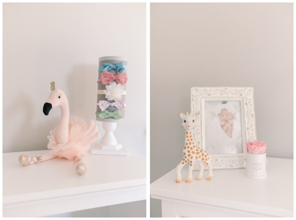 Details on the bookcase of a pink newborn nursery including a pink flamingo, headbands, photos, and Sophie the Giraffe.