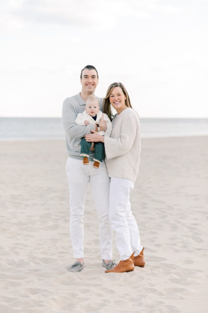 A family of three on the beach during winter family photos in NJ.