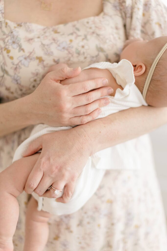 Choosing Privacy in the Age of AI Parent's arms wrapped around a swaddled newborn, faces intentionally out of frame